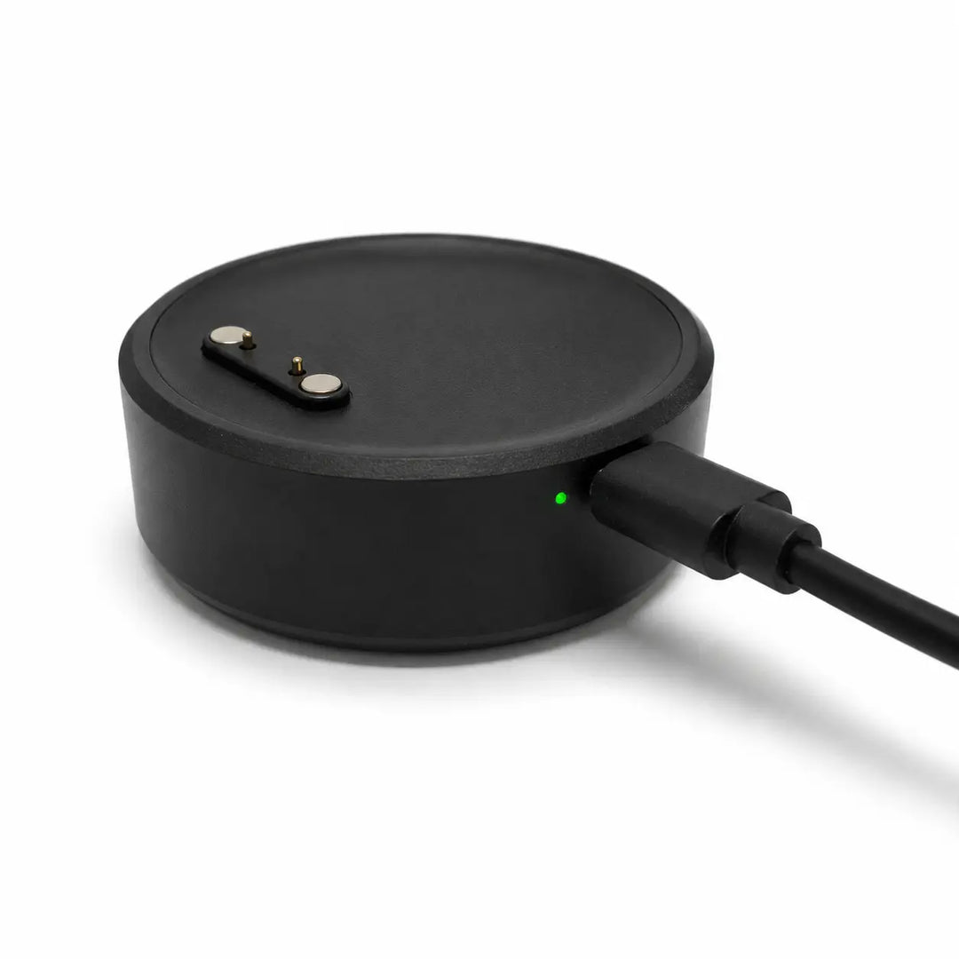 Lil Tracker portable charging dock plugged in with green charging indicator light